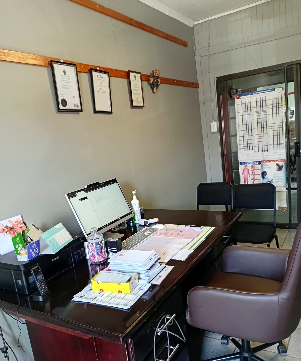 Dr Sogbesan's office with framed qualifications on the wall