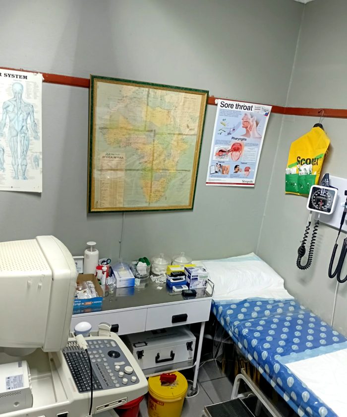 Examination room with an examination bed and blood pressure monitor